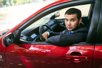 Fototapeta na wymiar Handsome young man driving a car.