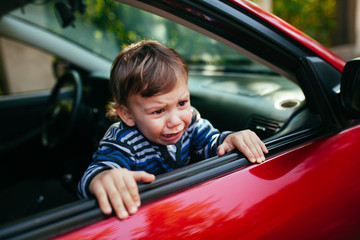 Crying baby boy in car.