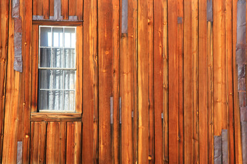 Obraz na płótnie Canvas Single window on old wooded plank wall