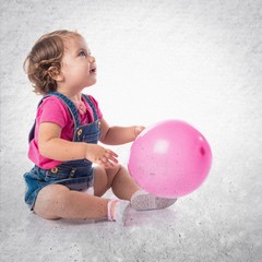 Baby playing with balloons