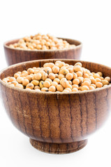 soybeans in wooden bowl isolated on white background..