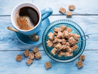 Cup of coffee and cane sugar cubes.