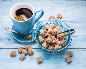 Cup of coffee and cane sugar cubes.