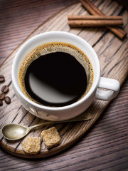 Cup of coffee and cane sugar cubes.