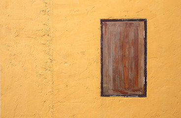 window with yellow wall background