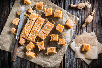 Sweet fudges with sesame on baking paper
