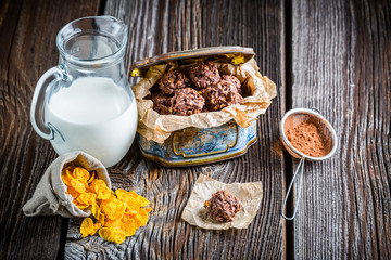 Homemade sweet chocolate balls with corn flakes and milk