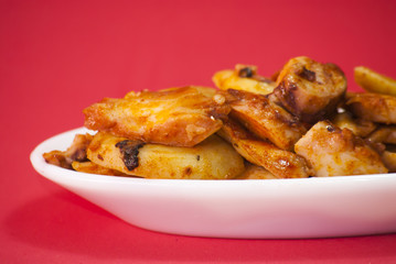 Octopus with paprika on a white plate, also known as Galician oc