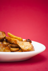 Octopus with paprika on a white plate, also known as Galician oc