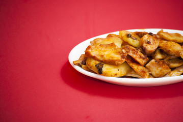 Octopus with paprika on a white plate, also known as Galician oc