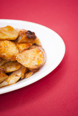Octopus with paprika on a white plate, also known as Galician oc