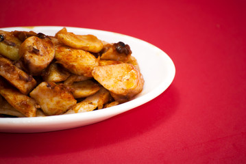 Octopus with paprika on a white plate, also known as Galician oc