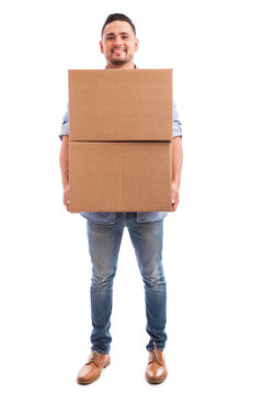 Young man carrying some boxes