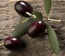 Olive oil and olives on the wooden table