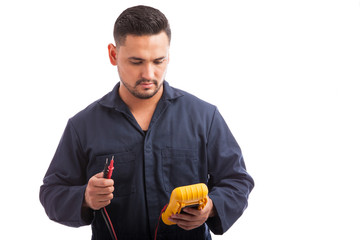 Electrician using a multimeter