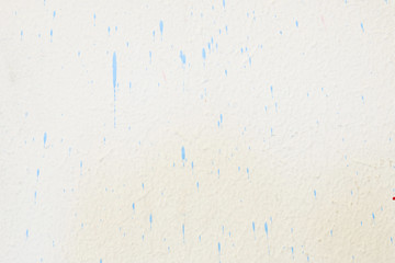 Dirty white painted cement wall with blue color drop texture background