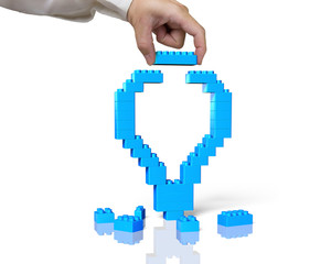 Hand holding blue block complete light bulb shape