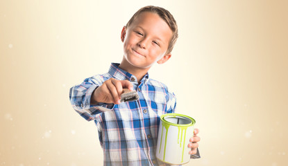 Kid holding a paint pot