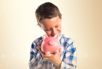 Kid holding a piggybank