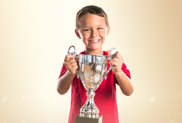 Kid holding a trophy