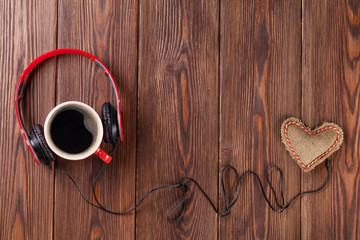 Heart toy with headphones and coffee cup
