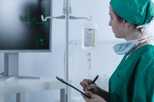 Doctor checking patient heartbeat