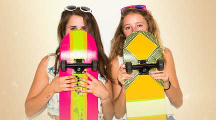 Two friends hiding behind their skateboards