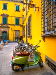 Fototapeta premium European motorbikes scooters vespas parked in Lucca Italy