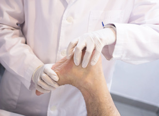 Orthopedic surgeon doctor examining patient foot