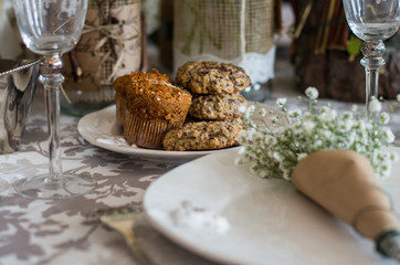 Cookies on the wedding table, decoration with bouquet of white gypsophilas in art paper /...