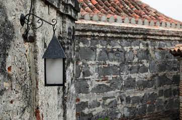 Vintage street iron lamp hanging on medieval wall 