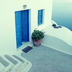 White house with blue windows in traditional village Oia, Santorini