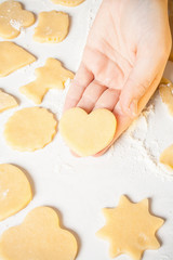 Girl shows heart shape out of dough