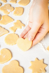 Girl shows heart shape out of dough