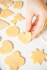 Girl shows heart shape out of dough