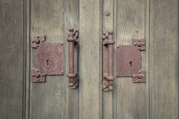 Old wooden door handle with pattern.