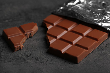 Chocolate bar in foil  on gray background