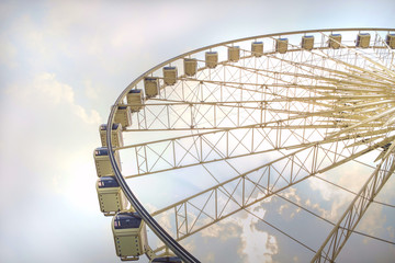 White ferris wheel/White ferris wheel at sunset with raincloud.