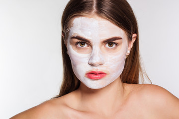 Beautiful girl with white clay facial mask