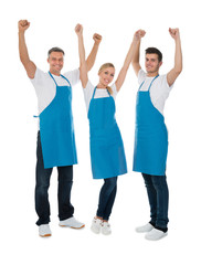 Obraz premium Happy Cleaners Raising Hands