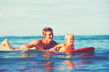 Father and Son Surfing - obrazy, fototapety, plakaty