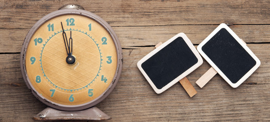 vintage clock and empty chalkboard over grunge background