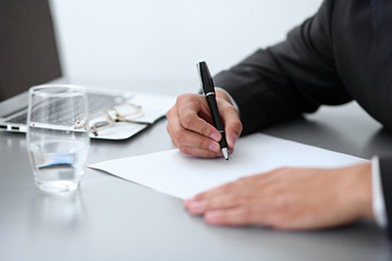 Close-up of male hands with pen over document,  business concept