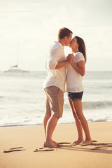 Young Couple Kissing on the Beach at Sunset