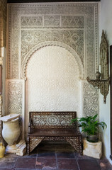 Ornate bench and archway in courtyard in Cordoba Spain