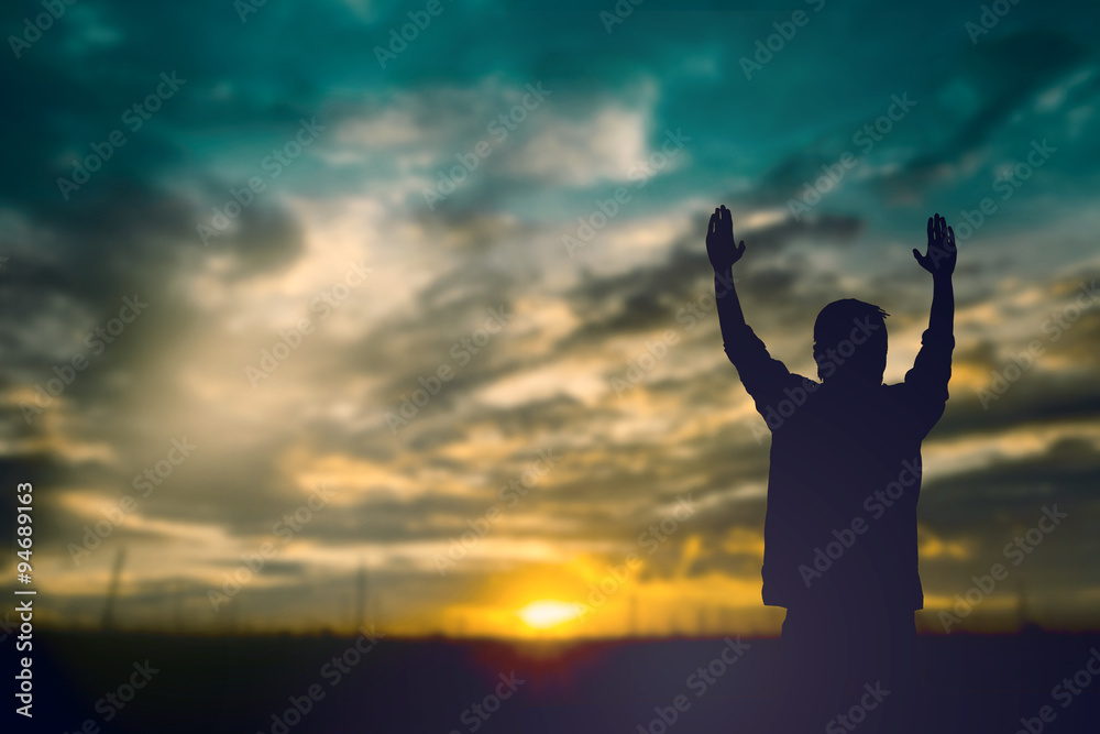 Wall mural Silhouette of man with raised hands over blur cross concept for - Wall murals