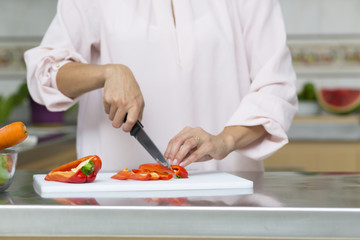 Closeup on woman cutting fresh vegetables