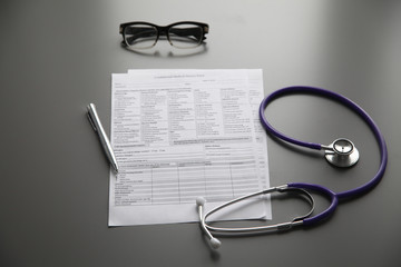 Stethoscope on the grey desk, close up