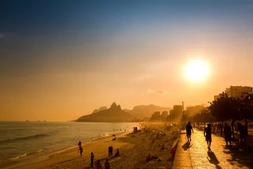 Foto op Plexiglas Copacabana, Rio de Janeiro, Brazilië Unidentifiable silhouettes enjoy late afternoon sun rays on Ipanema beach in Rio de Janeiro, Brazil.  Ipanema is one of the most expensive places to live in Rio,