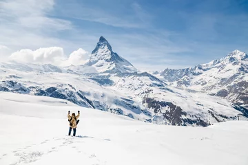 Papier Peint photo Cervin A man celebrate success with the background of Matterhorn.